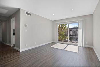 A room with a large window and a view of a parking lot.